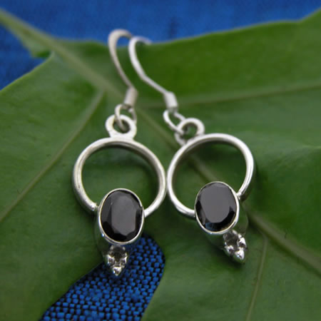 Sterling silver dangleswith a cabochon stone of rainbow moonstone.